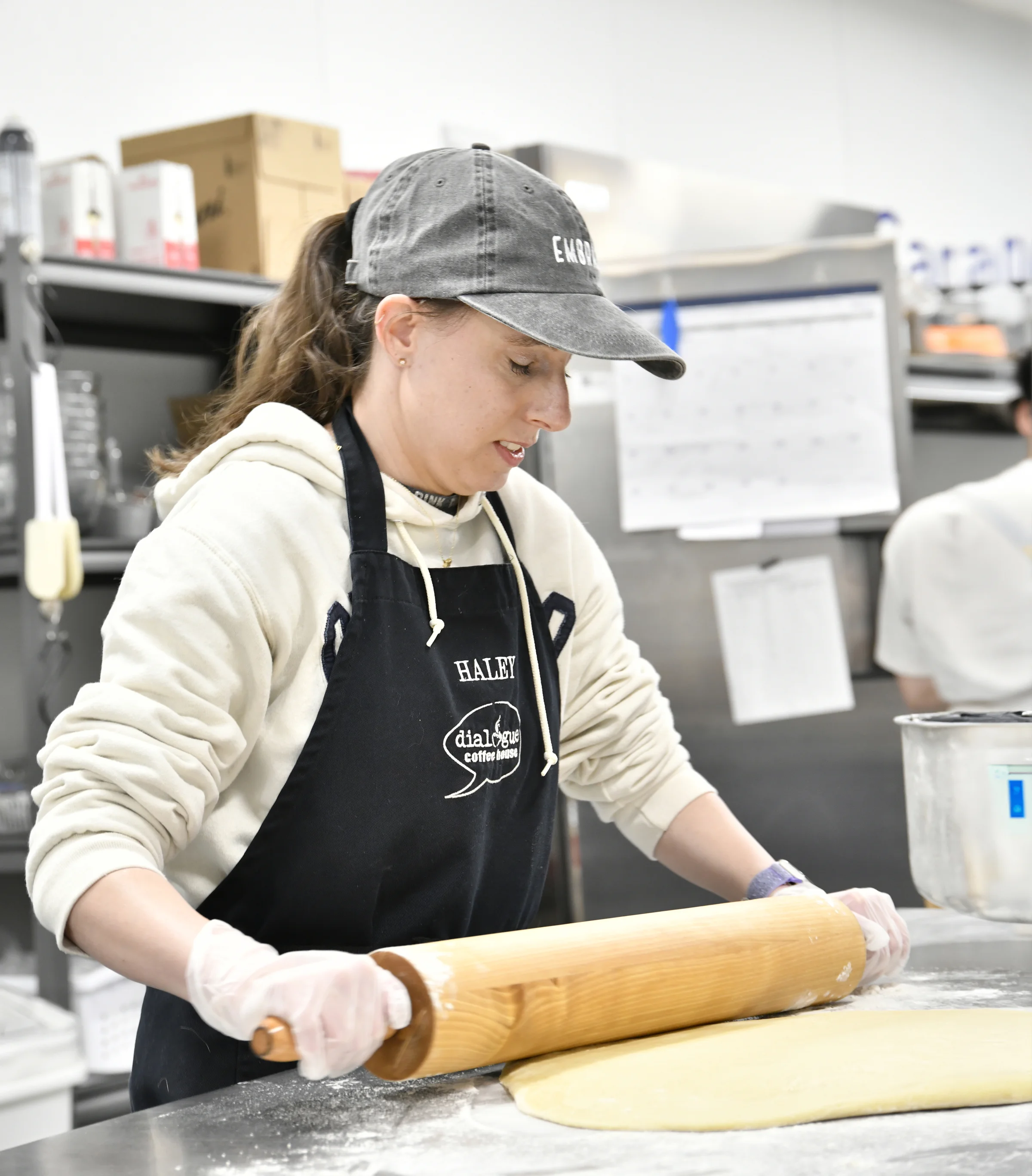 Baker rolling dough in a modern kitchen