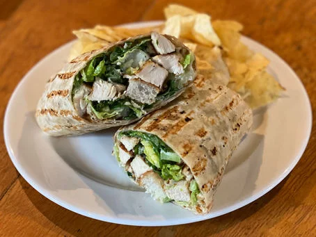 Grilled chicken wrap with lettuce and chips