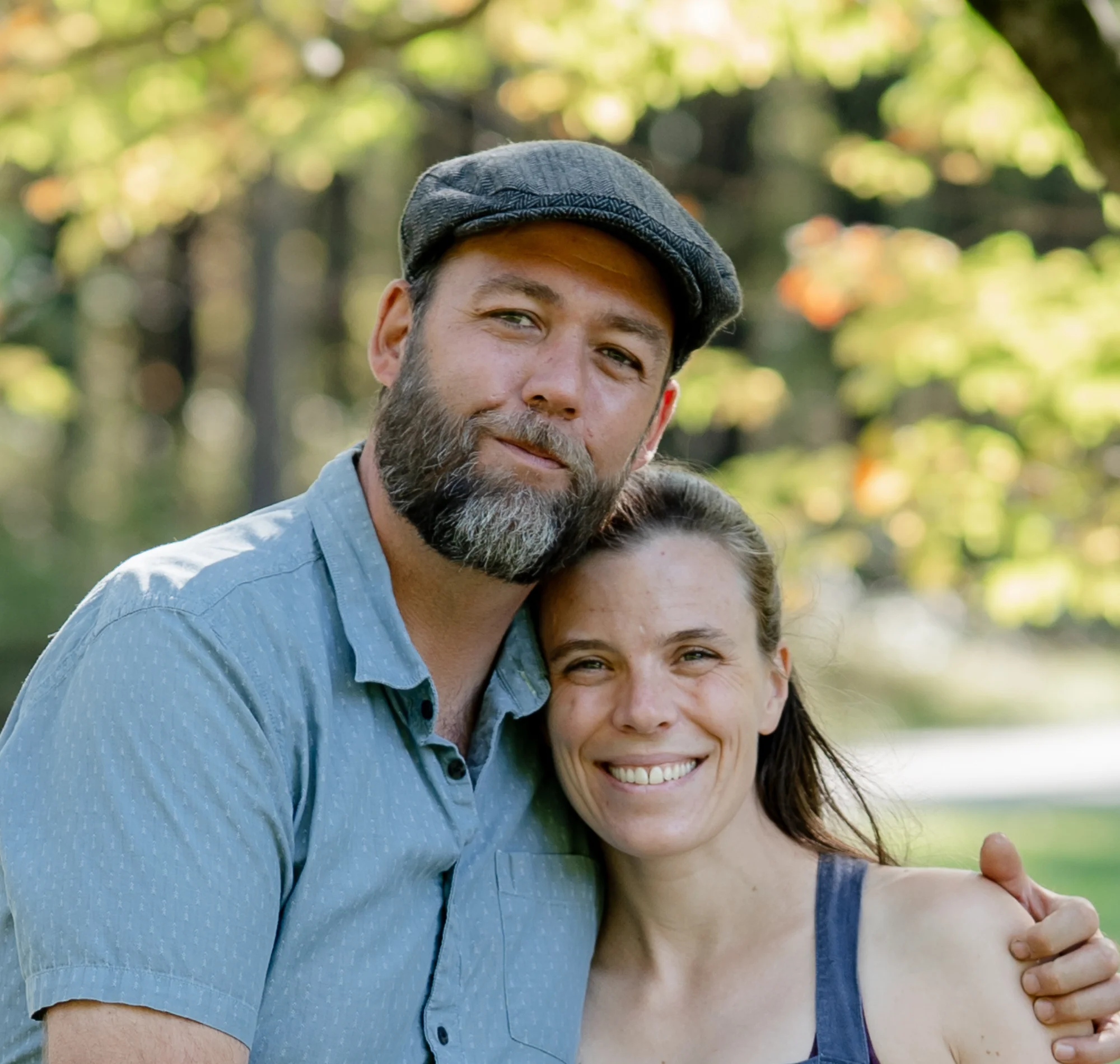 Couple embracing outdoors in a sunny park setting
