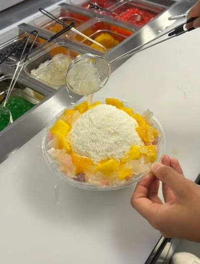 Colorful bowl of Filipino halo-halo dessert with shaved ice