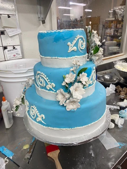 Blue fondant tiered cake with sugar flowers from The Kosher Pastry Oven