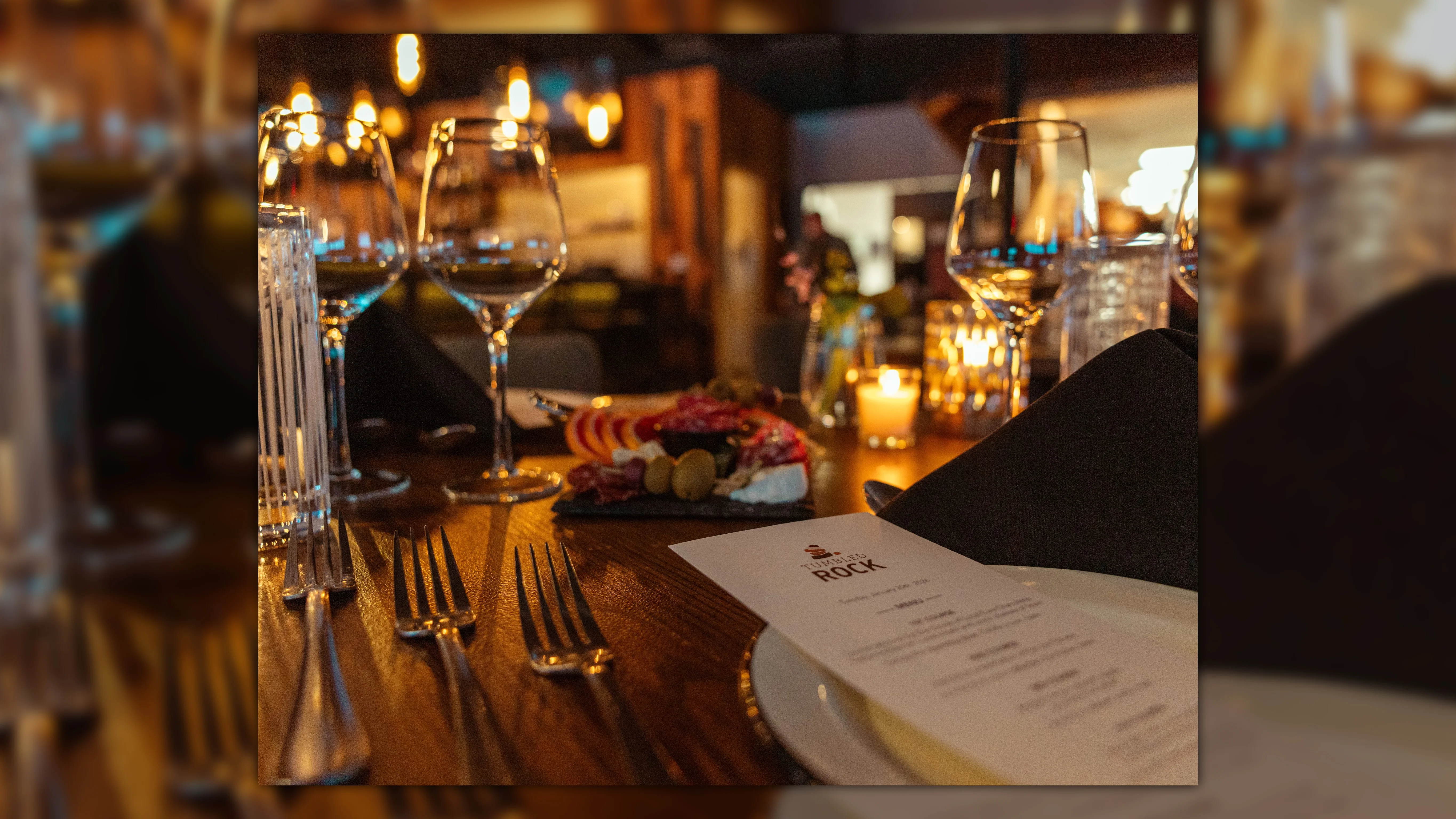 Elegant restaurant table setting with wine and charcuterie