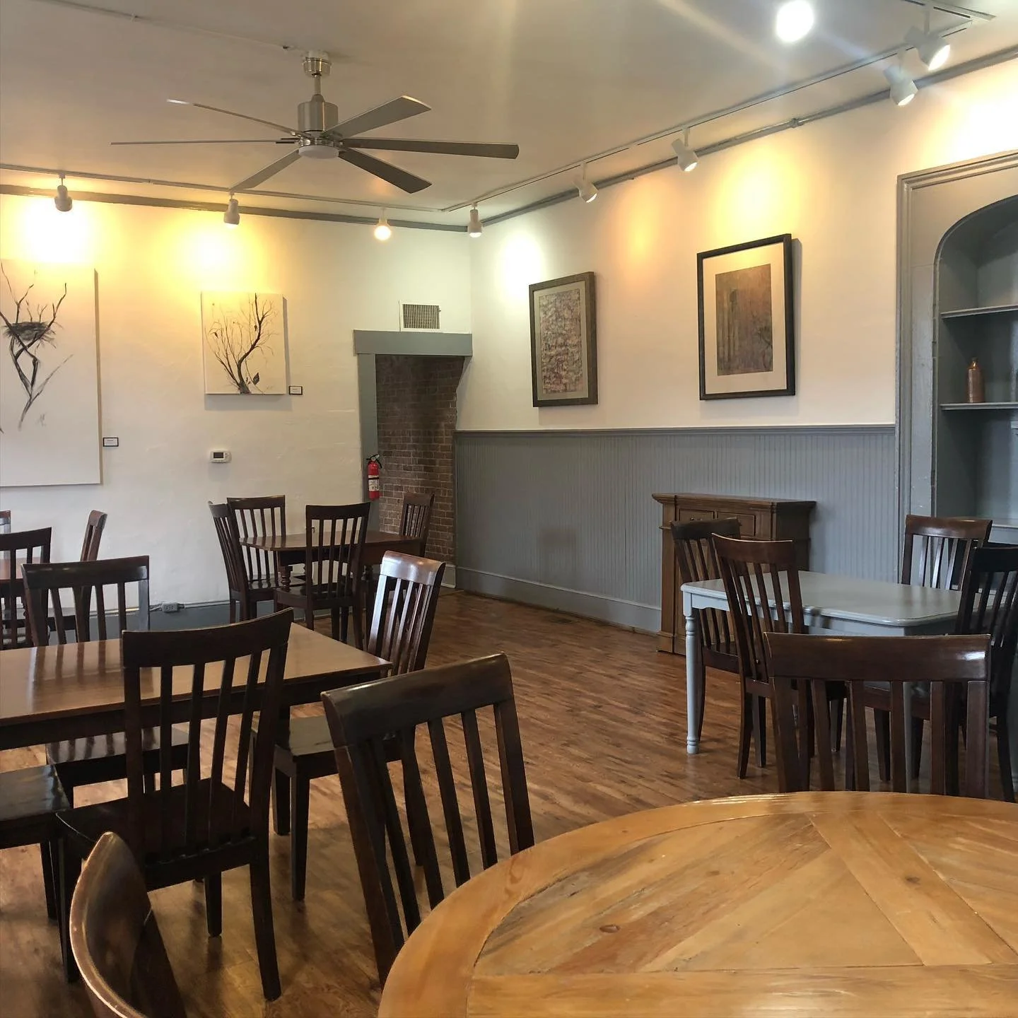 Cozy restaurant interior with wooden tables and artistic decor
