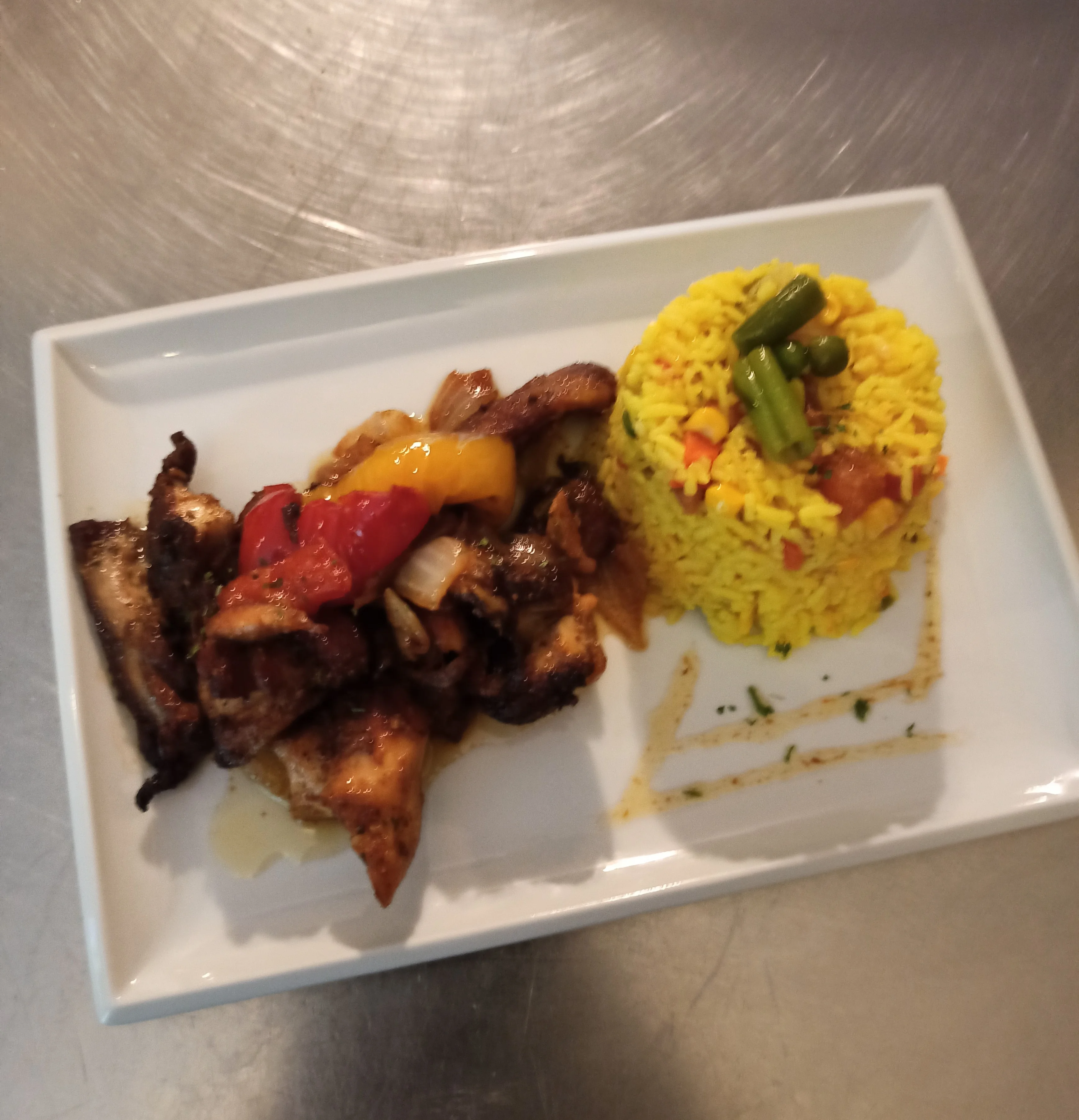 Jamaican jerk chicken with yellow rice and vegetables