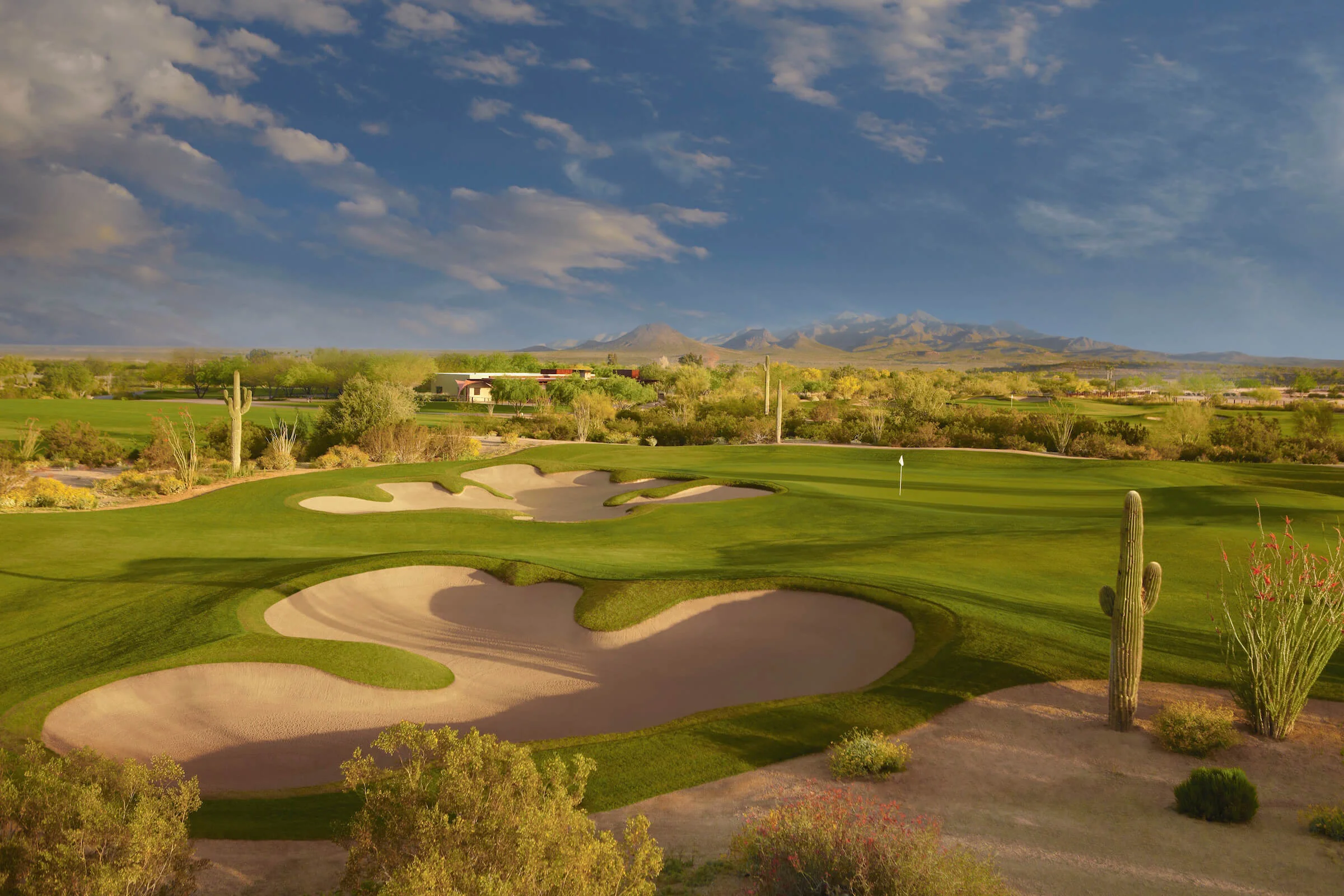 Scenic golf course with sand traps and desert landscape