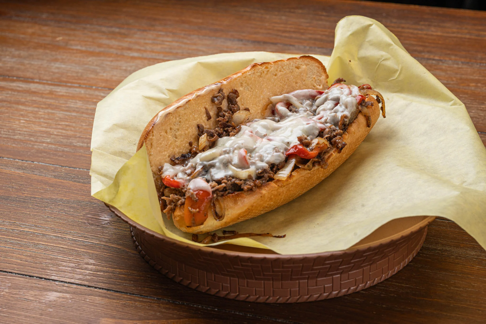 A traditional cheesesteak sandwich with melted cheese and grilled meat on a hoagie roll.