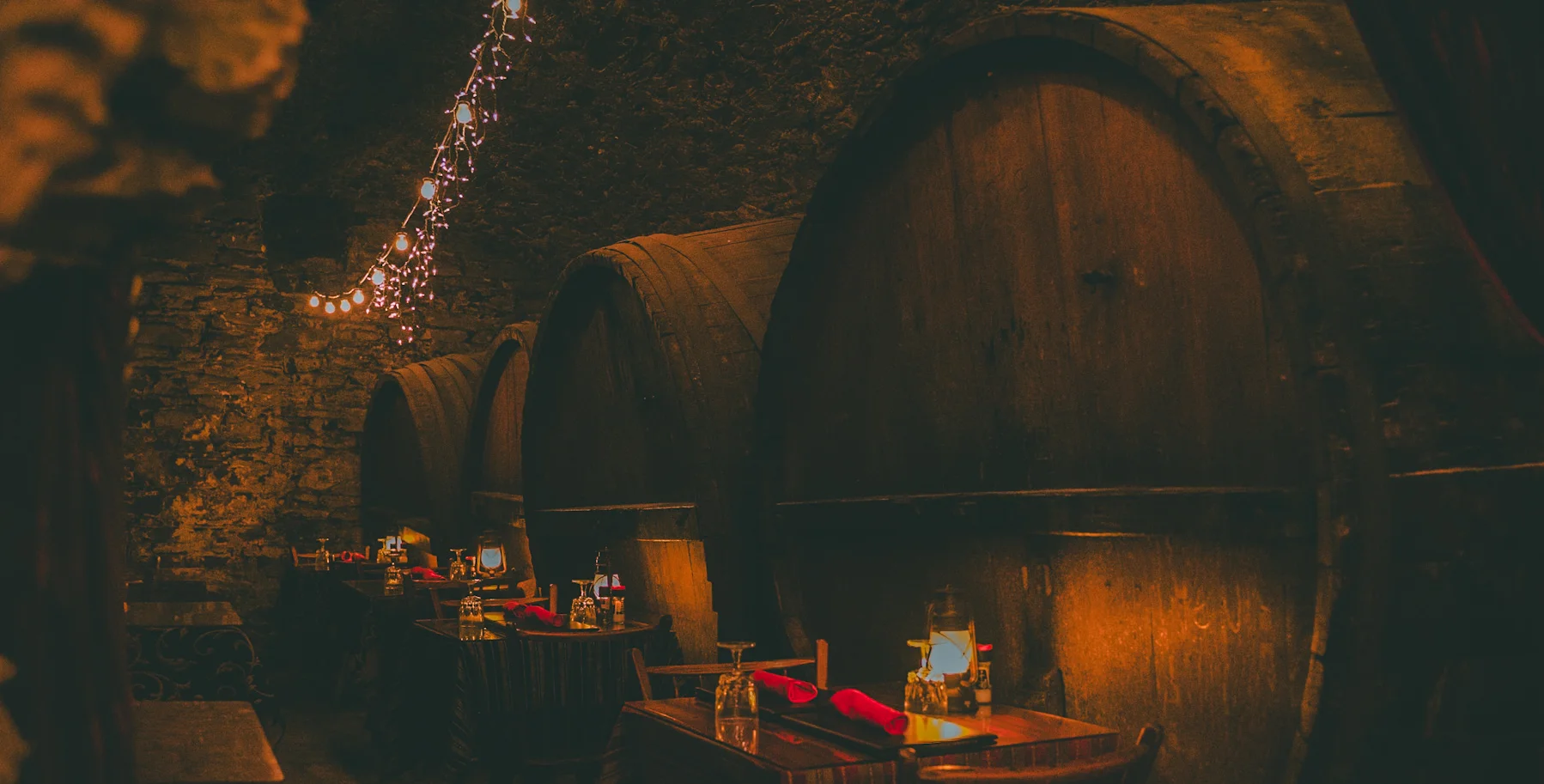 Cozy restaurant interior with stone walls and candlelit tables