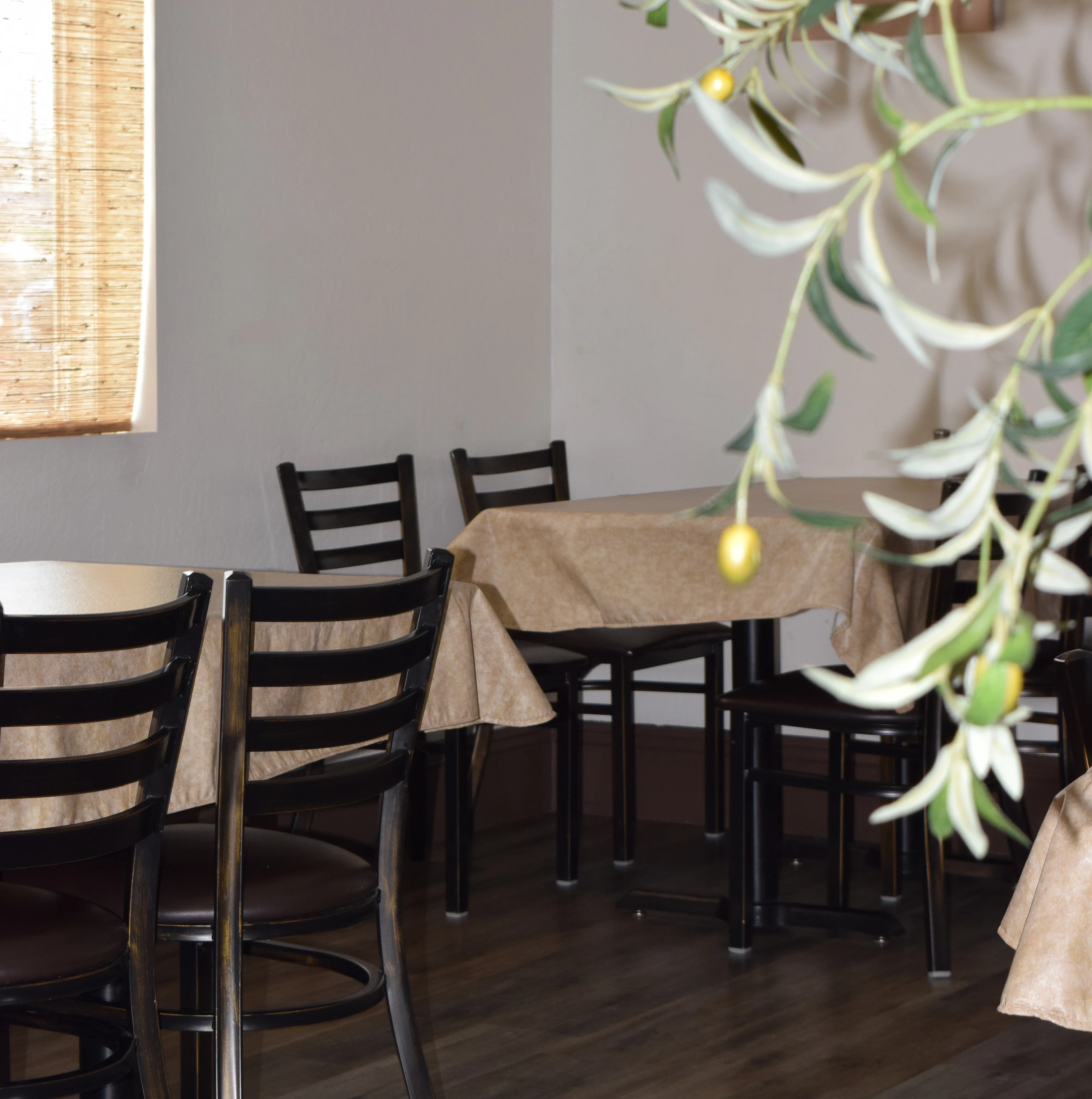 Cozy restaurant interior with wooden tables and olive decor