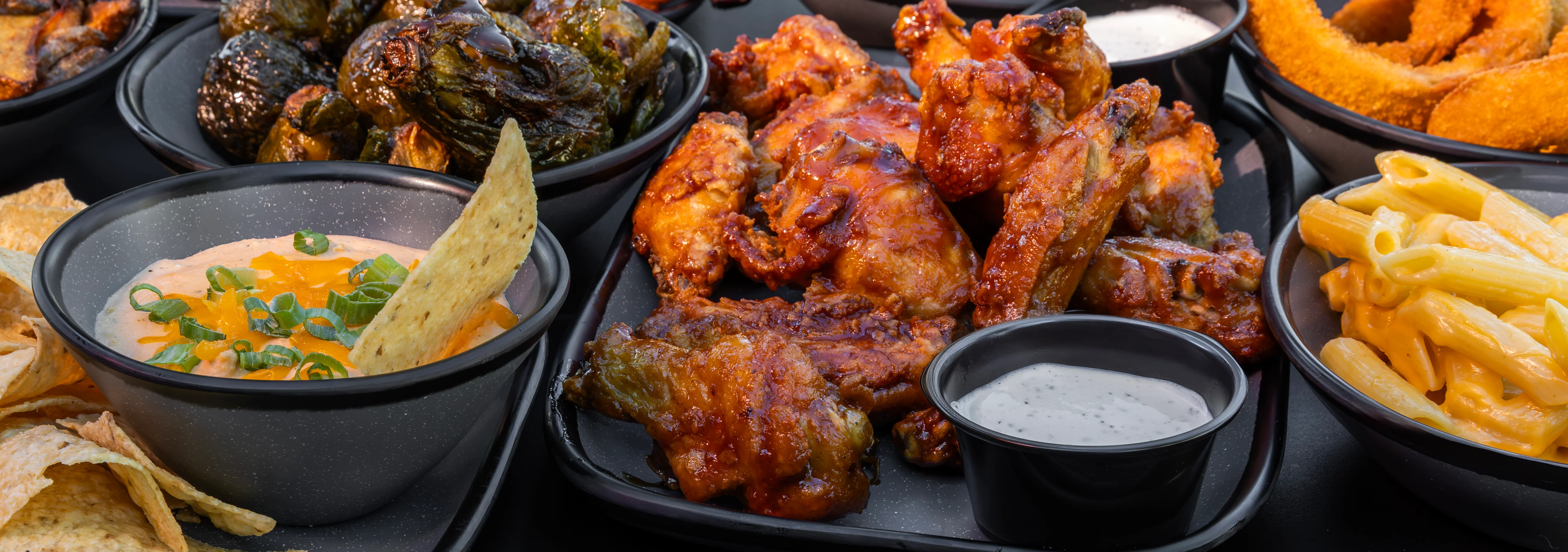 Assorted barbecue platter with ribs, wings, and sides