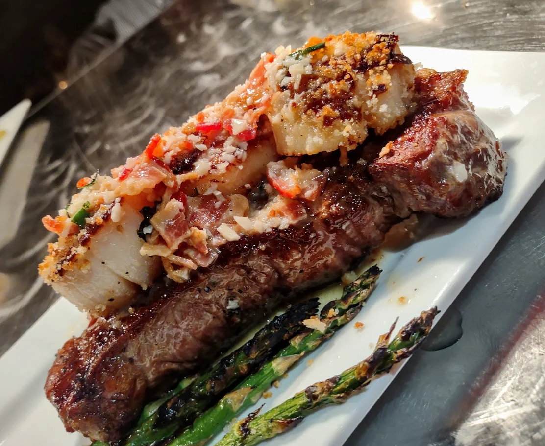 Grilled steak with savory topping and asparagus