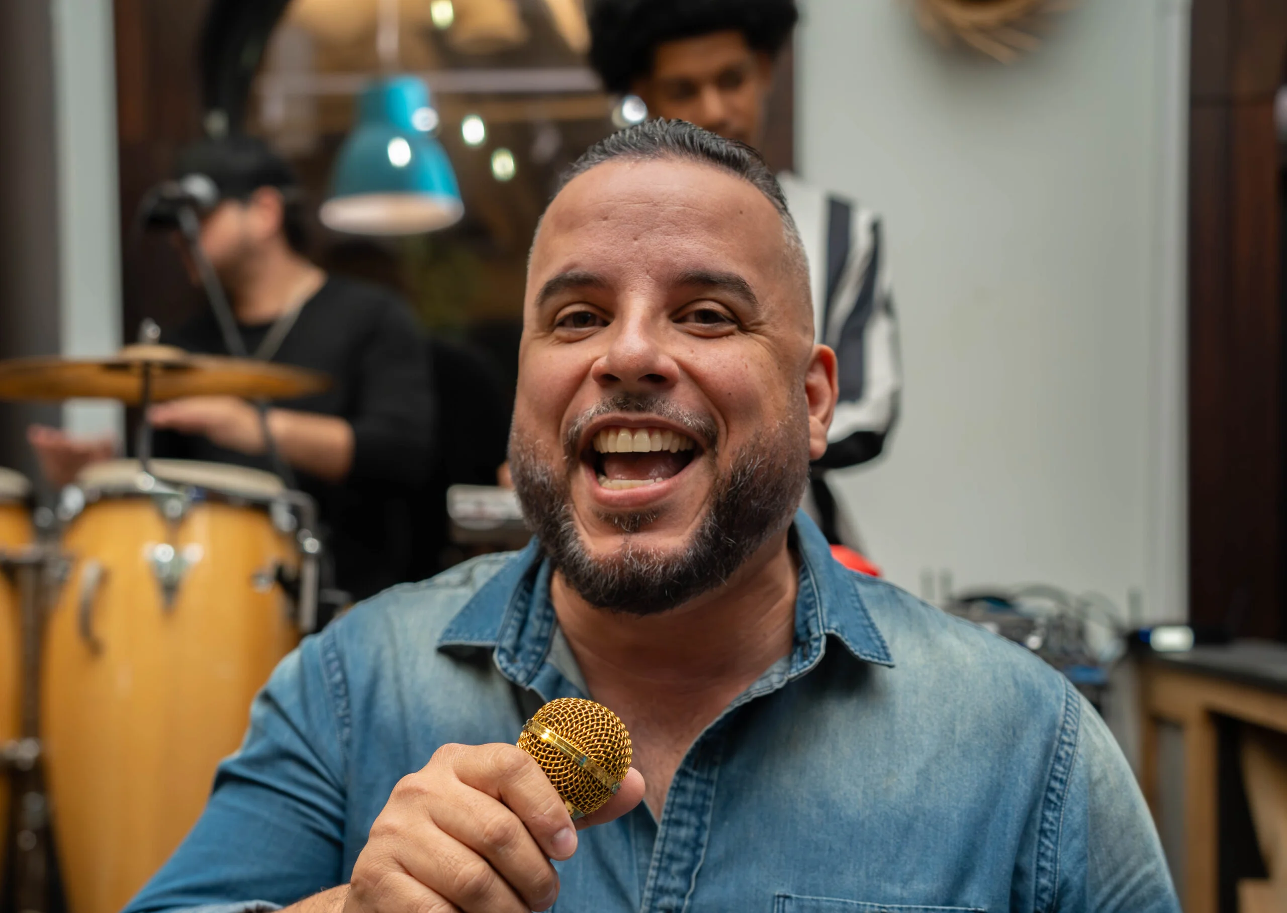 Singer performing with a golden microphone at a lively restaurant event