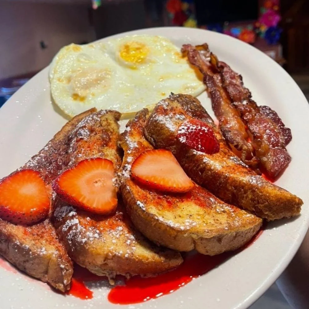 Delicious French toast with strawberries and eggs