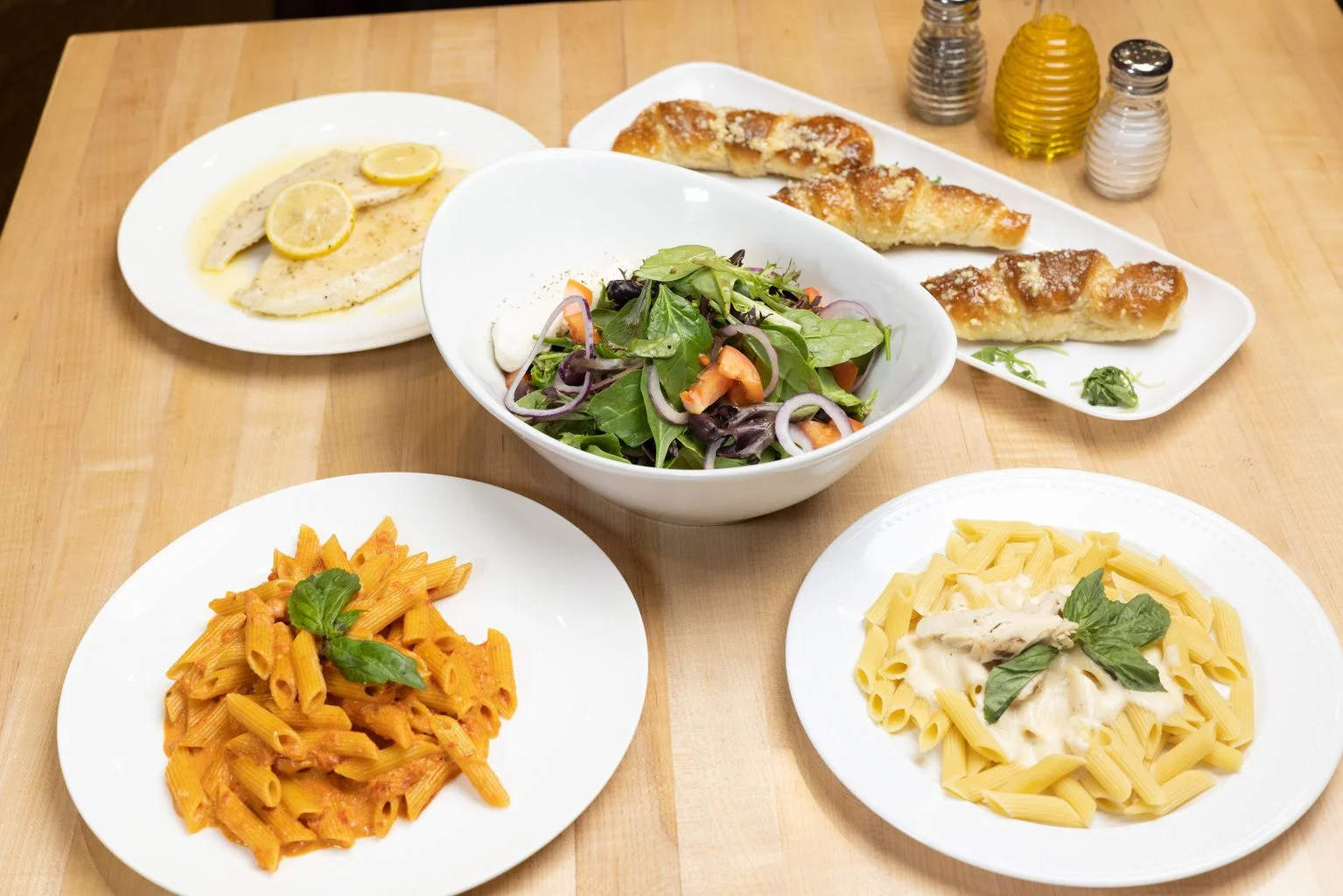Italian pasta dishes with salad and fish fillet