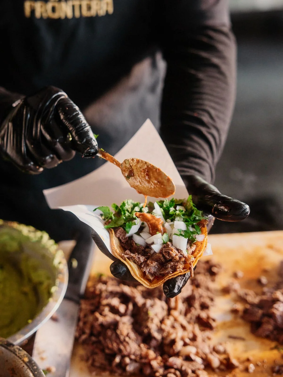 Delicious gourmet burger with fresh toppings on a wooden table