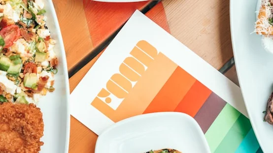 Colorful restaurant menu with various dishes on a wooden table