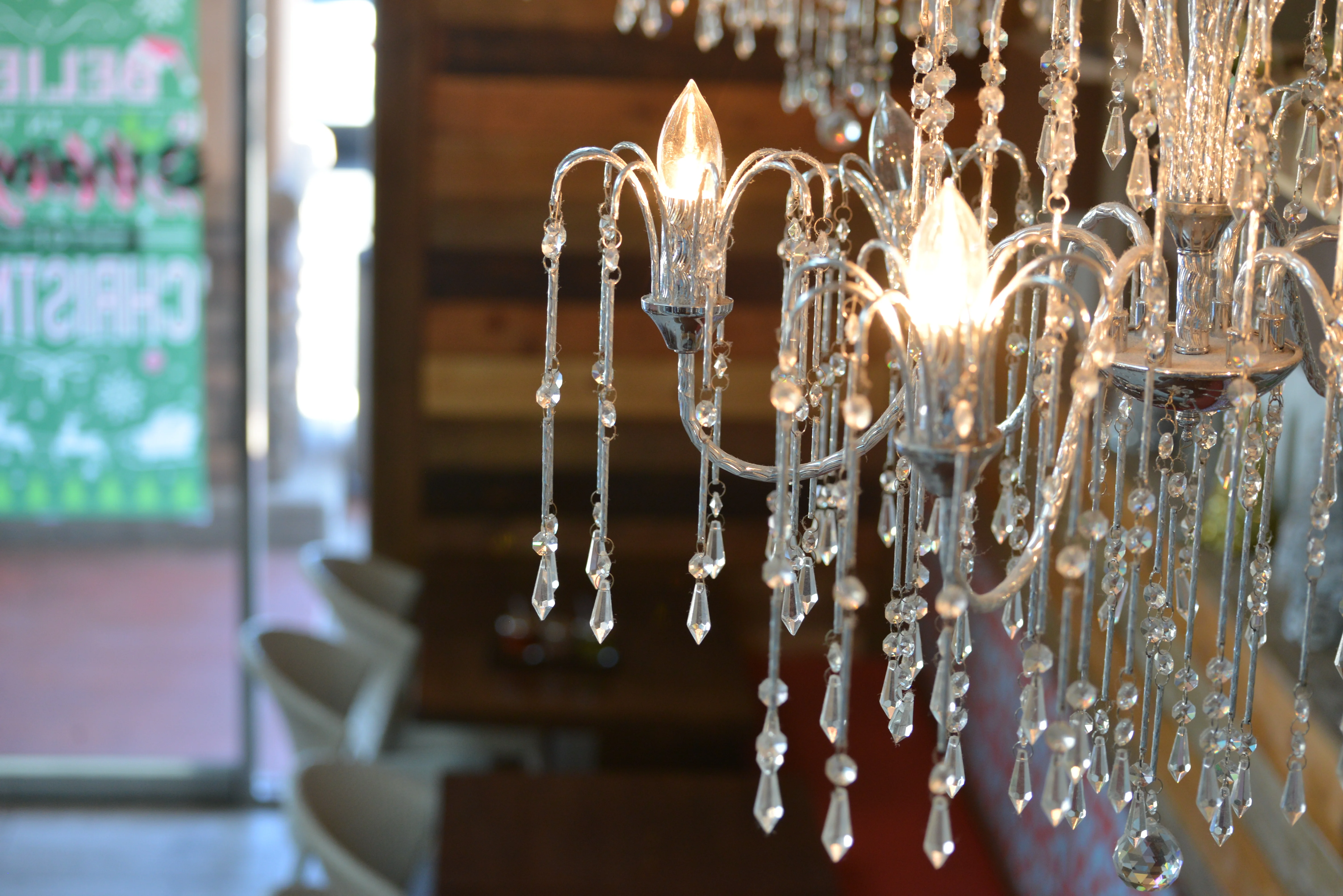 Elegant chandelier illuminating a cozy restaurant interior