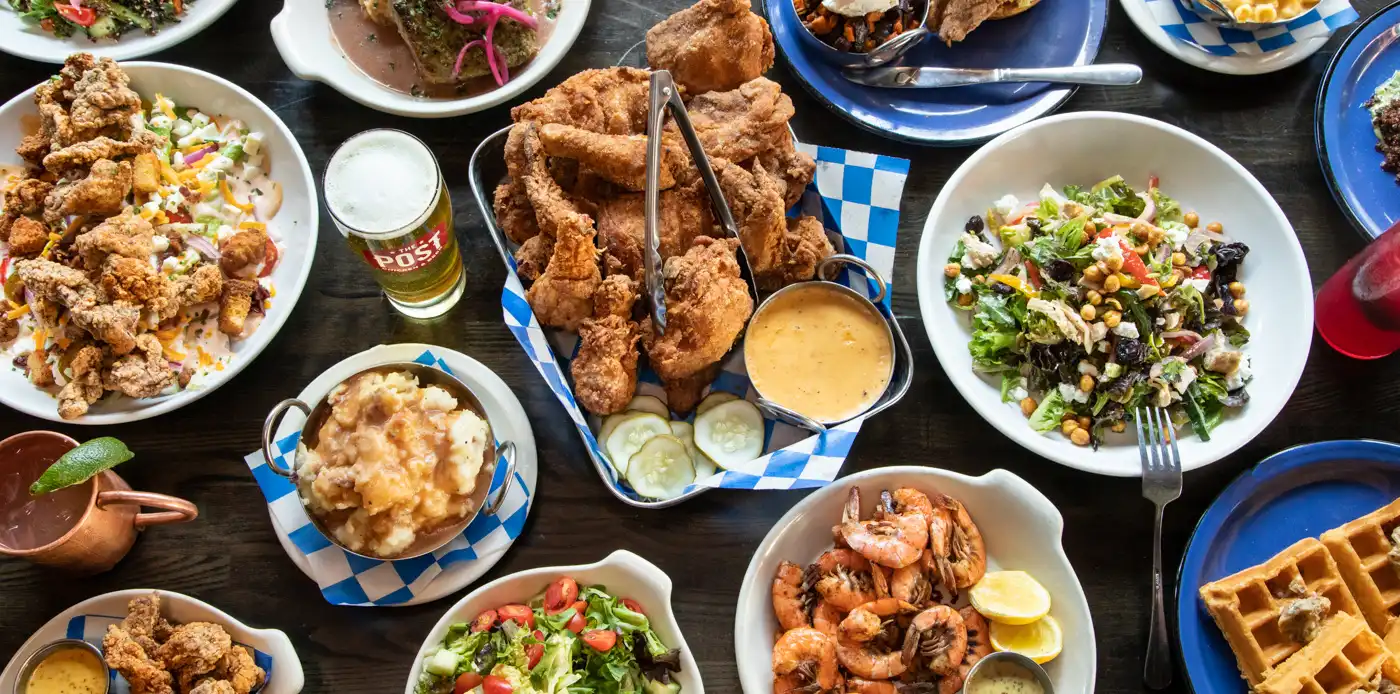 plates of fried chicken and food on table 