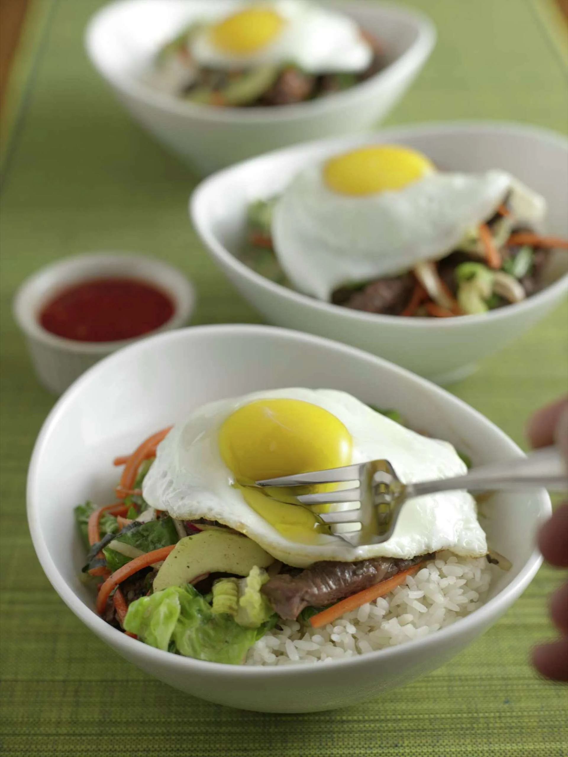 Korean bibimbap topped with a fried egg