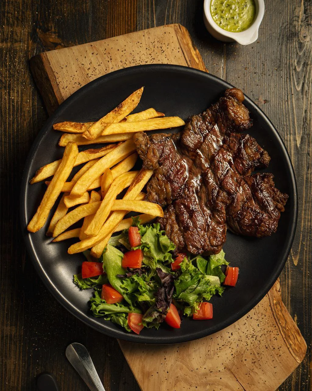 Grilled Argentine steak with fries and fresh salad