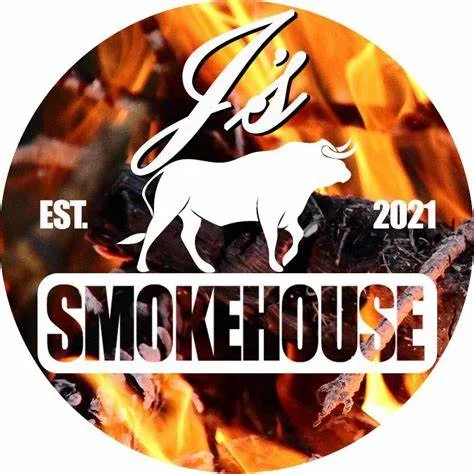Logo of J's Smokehouse established in 2021 with a bull and flames background