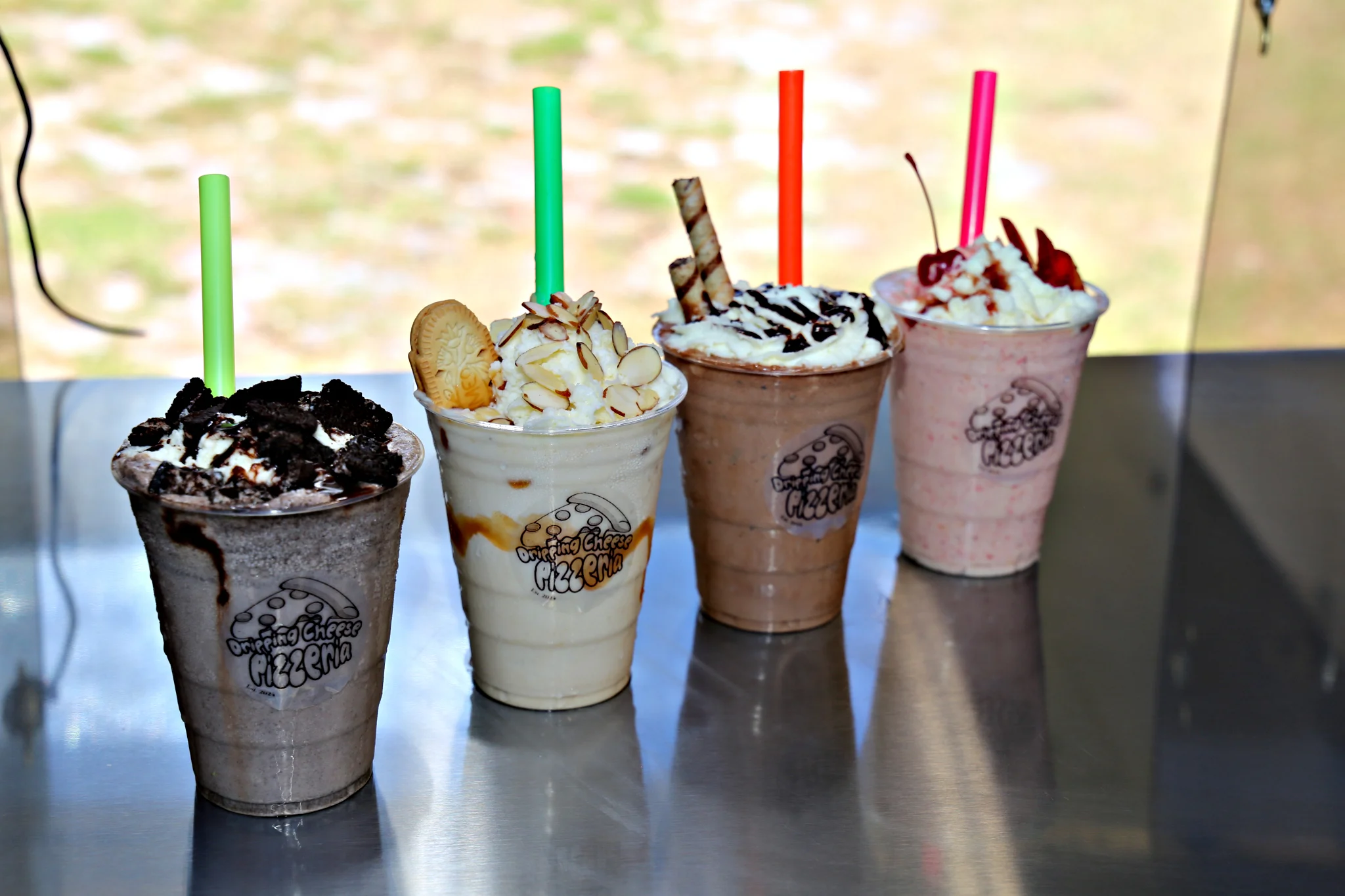 Delicious milkshakes in colorful cups from a pizzeria