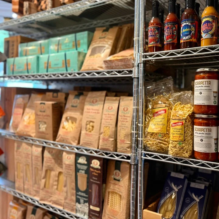 Gourmet pasta sauces and condiments on a well-organized grocery shelf