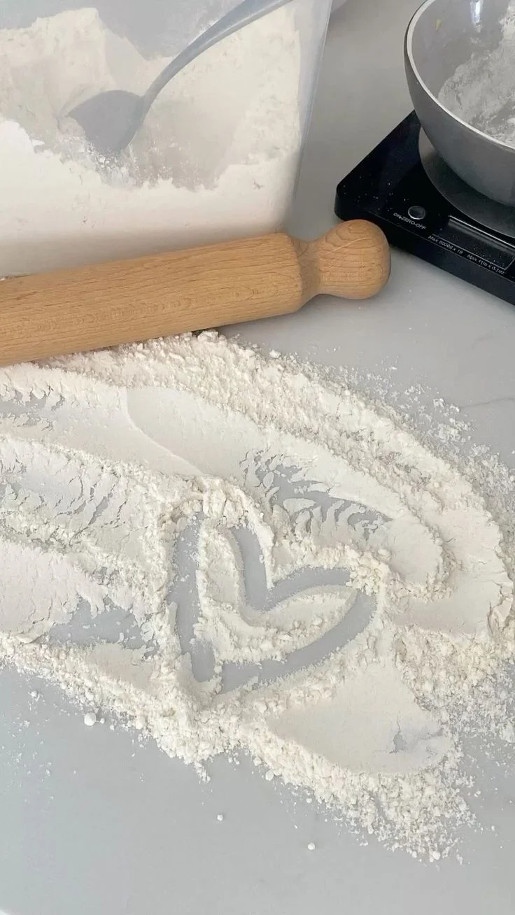 Baking scene with flour and rolling pin on a countertop