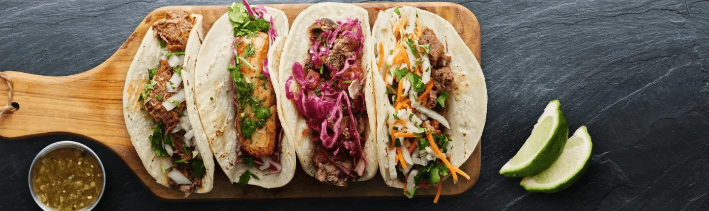 Assorted Mexican tacos on a wooden board