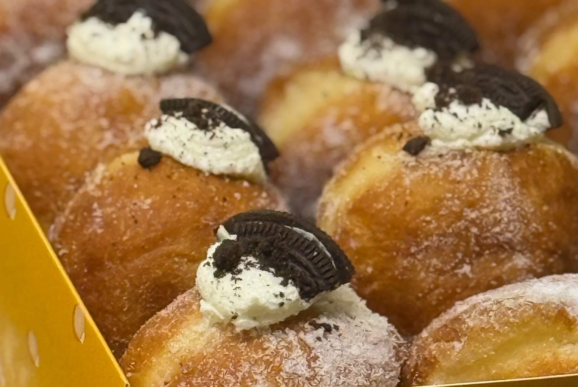 Delicious Oreo cream-filled doughnuts in a vibrant box