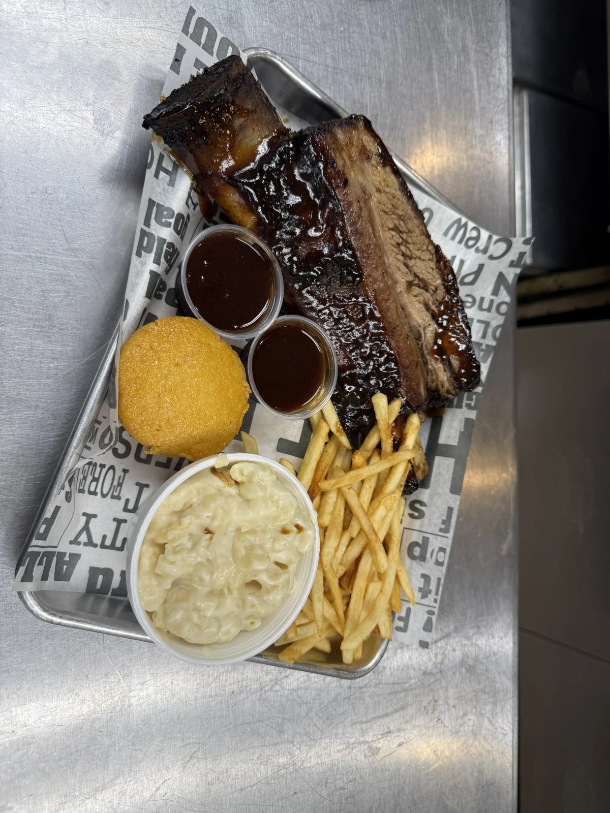 Southern barbecue ribs and brisket platter with fries and macaroni salad