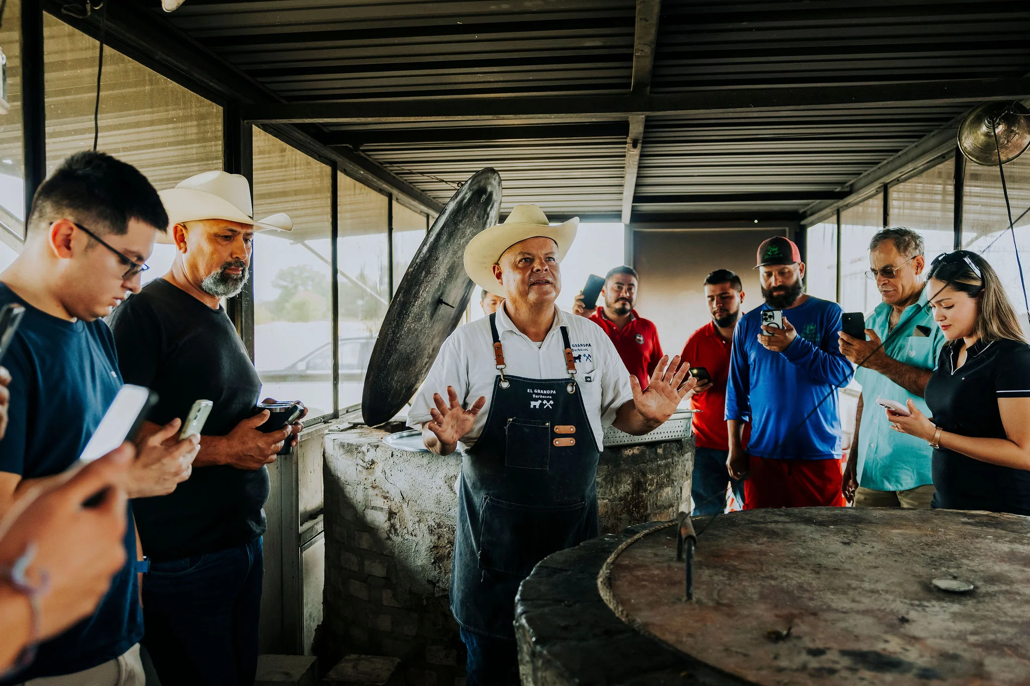 Chef demonstrating traditional cooking techniques to an engaged audience