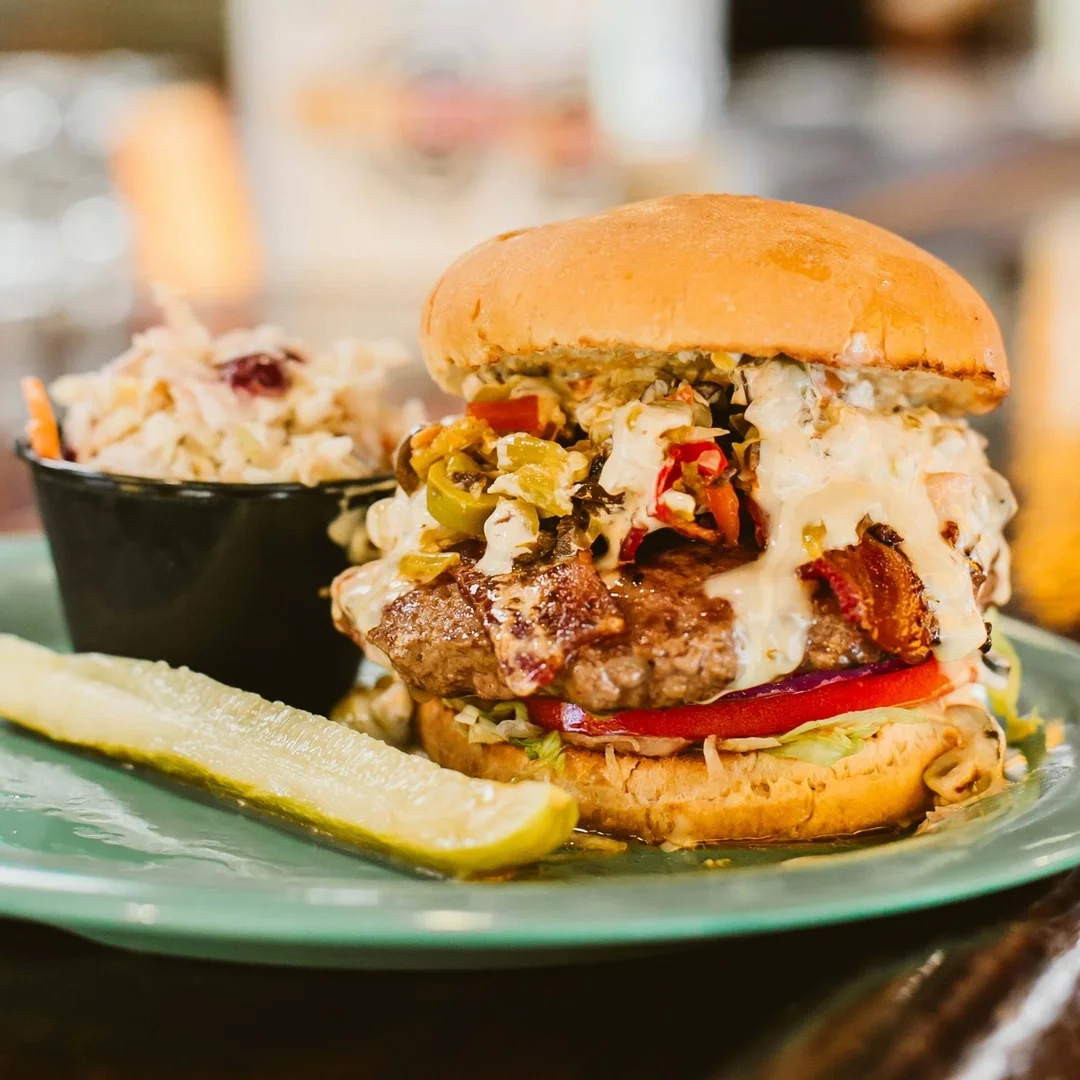 Juicy American cheeseburger with coleslaw and pickles