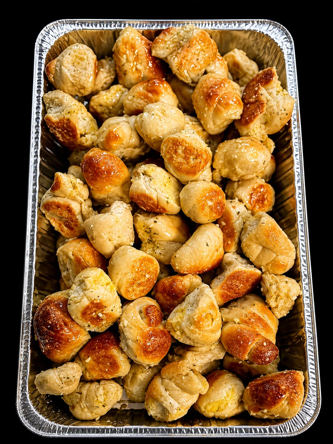 Golden garlic knots in a serving tray