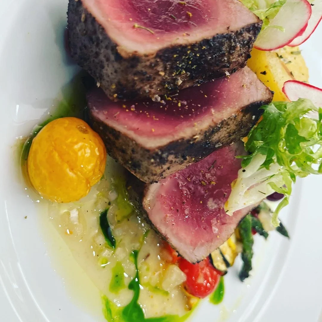 Seared tuna steak with vibrant vegetable garnish