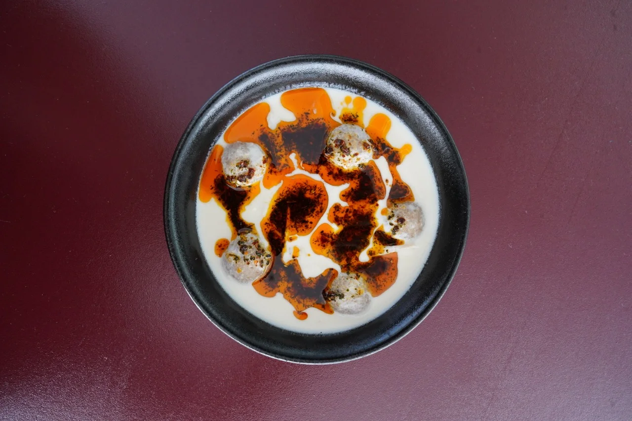 Turkish yogurt soup with meatballs and spicy oil drizzle