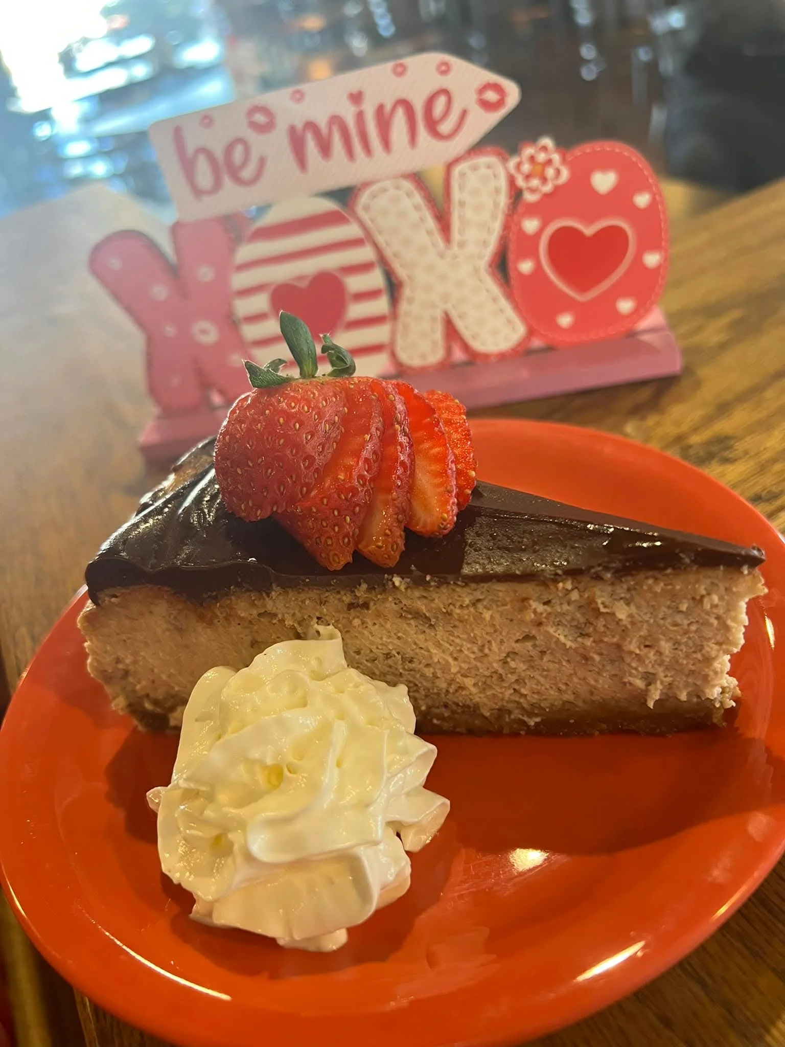 Decadent chocolate cheesecake slice with strawberries