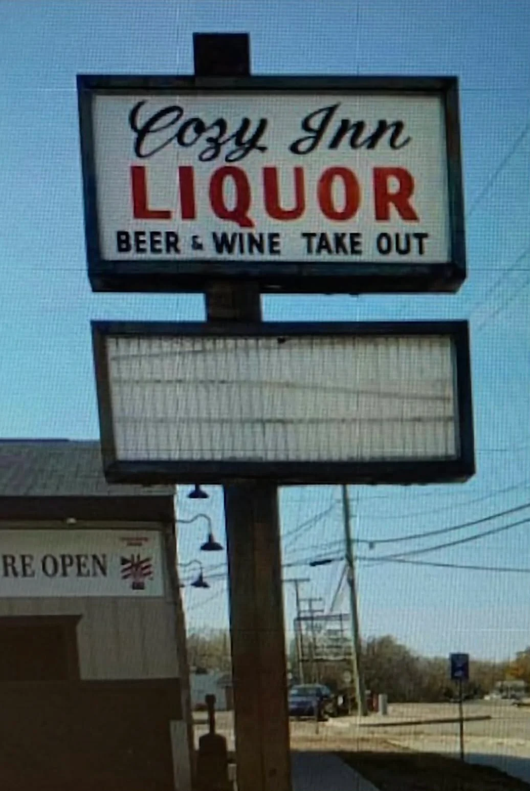 Cozy Inn liquor store sign with beer and wine takeout