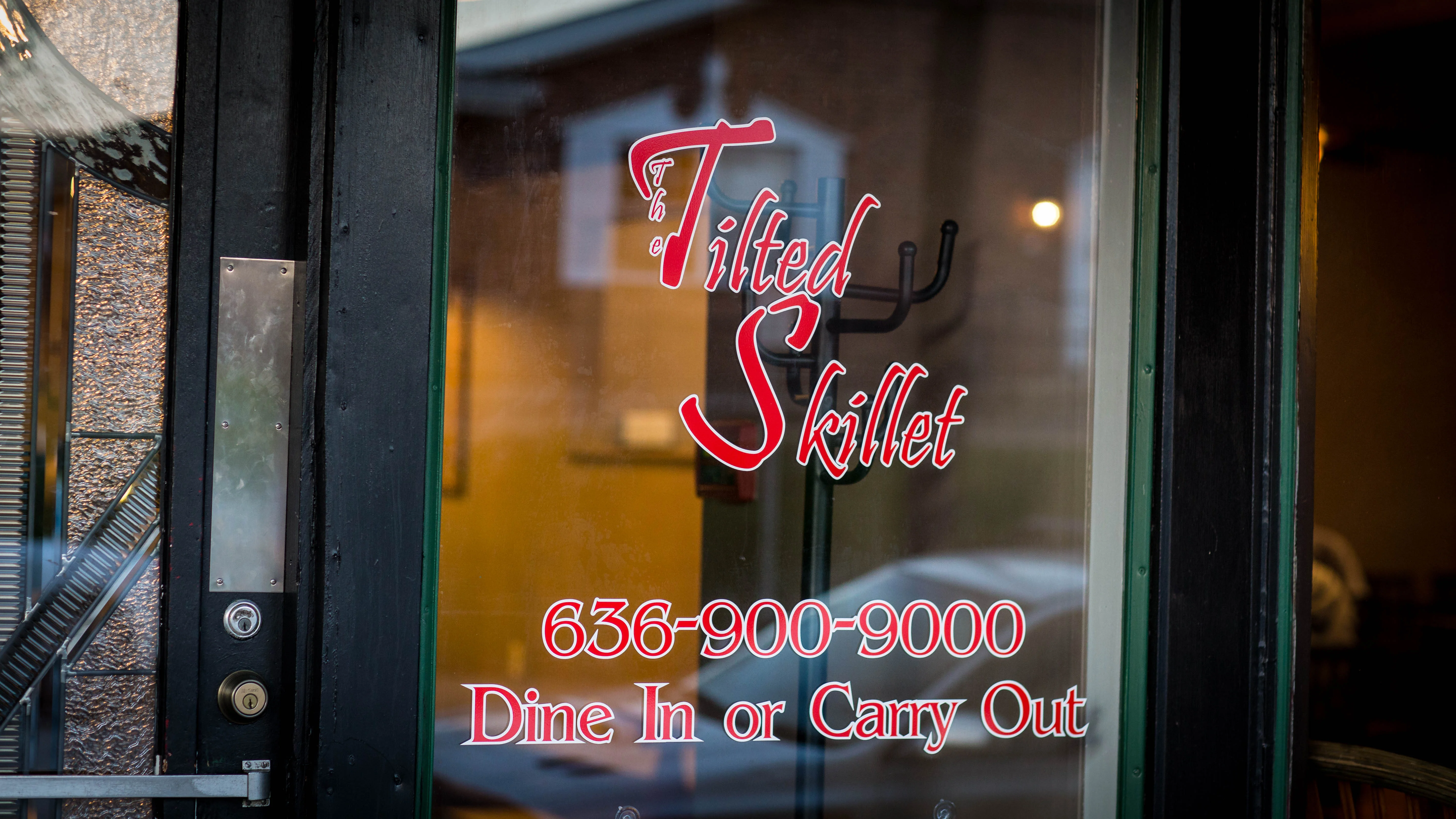 Restaurant entrance of The Tilted Skillet with dine-in and carry-out options