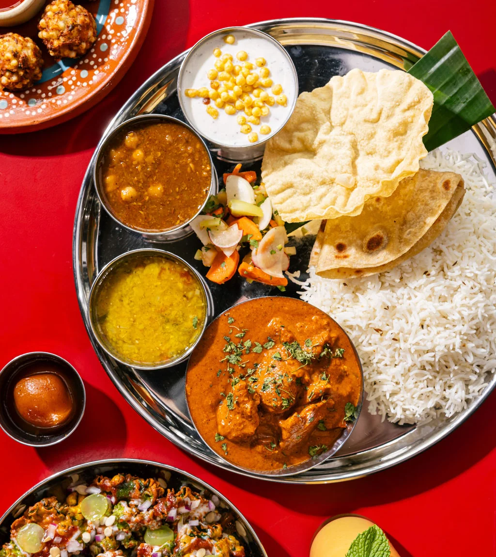 Traditional Indian thali with curry, rice, and sides