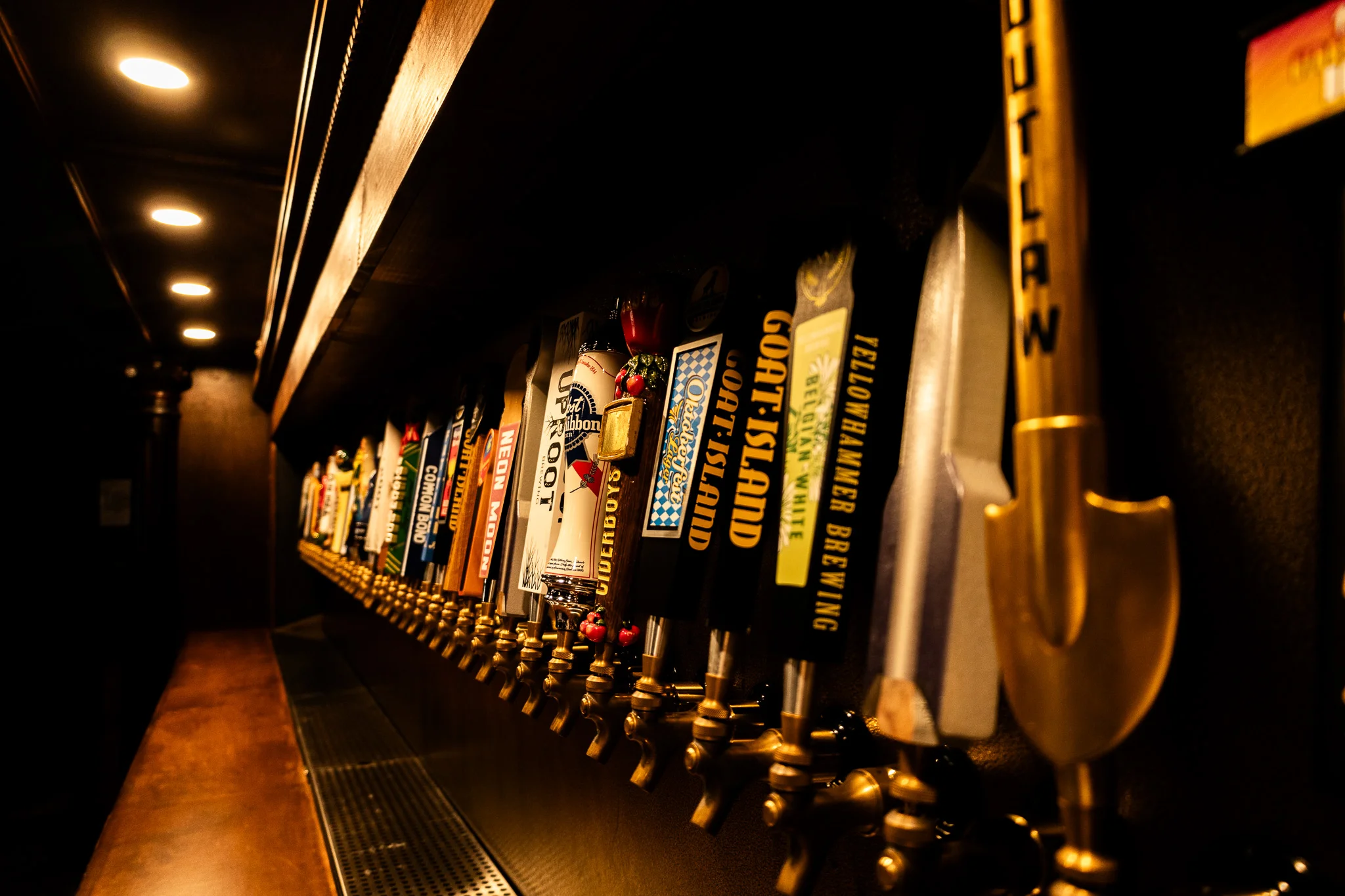 Variety of craft beer taps at a bar