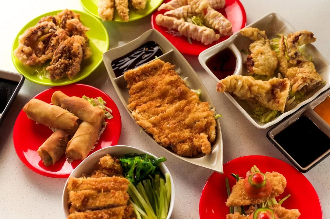 Assorted Asian appetizers including spring rolls and fried chicken