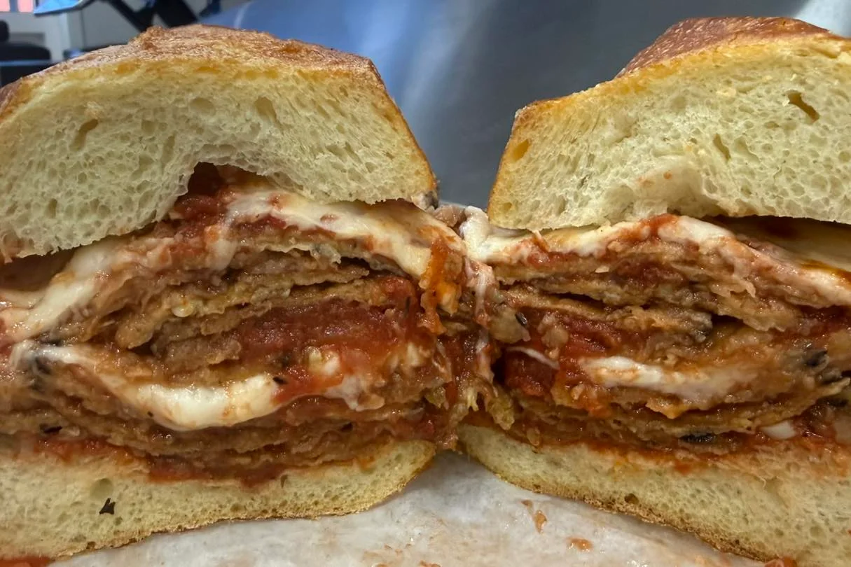Delicious eggplant parmesan served with marinara sauce and cheese.