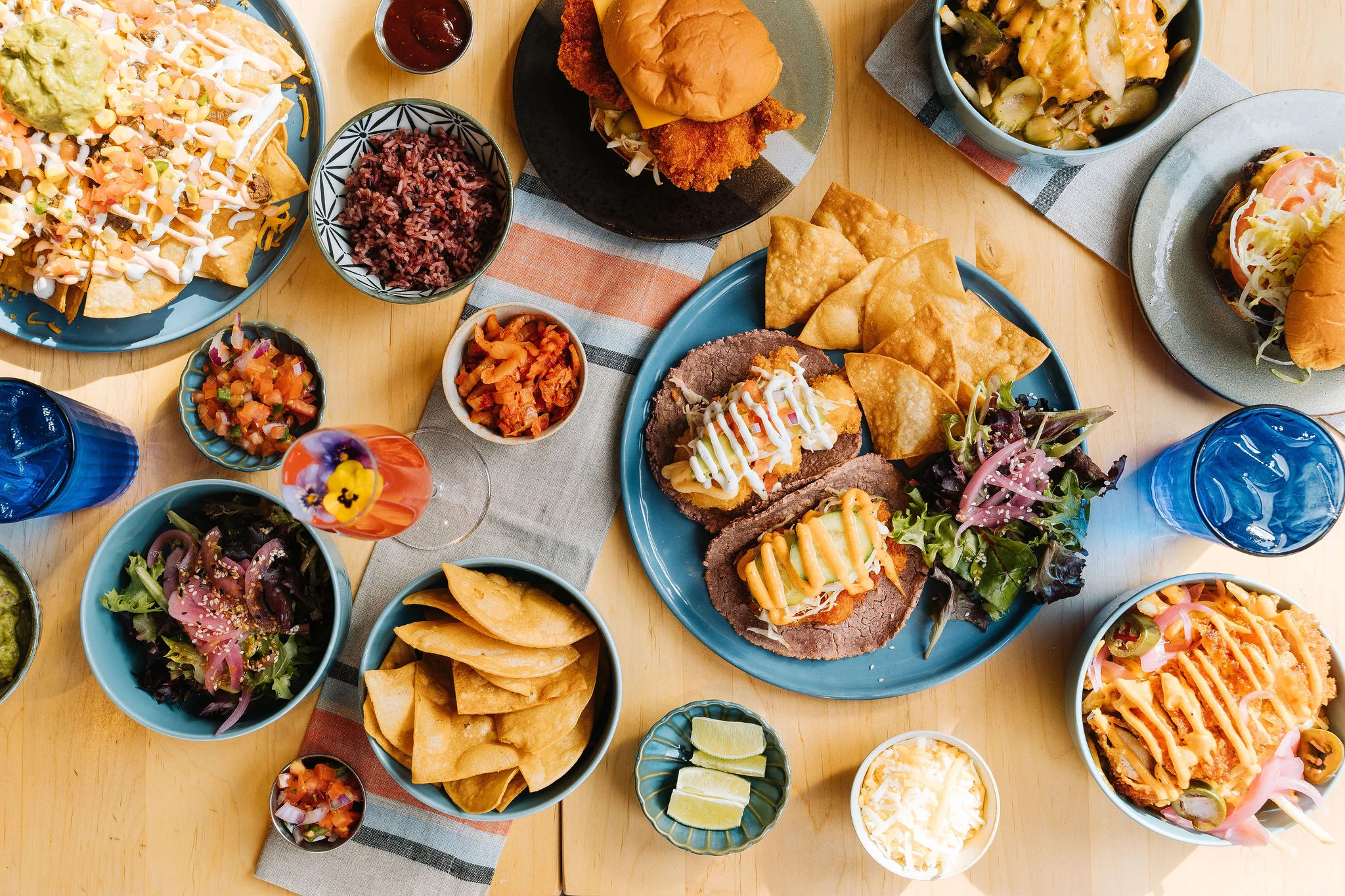 Colorful Mexican feast with tacos, nachos, and fresh salsas