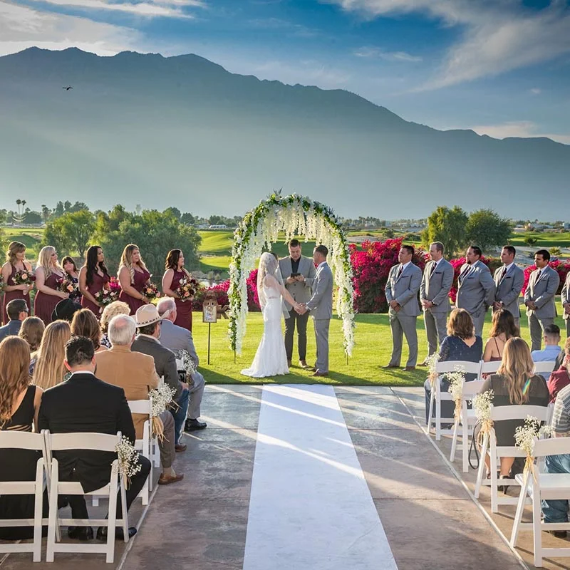 Outdoor wedding ceremony with mountains in the background
