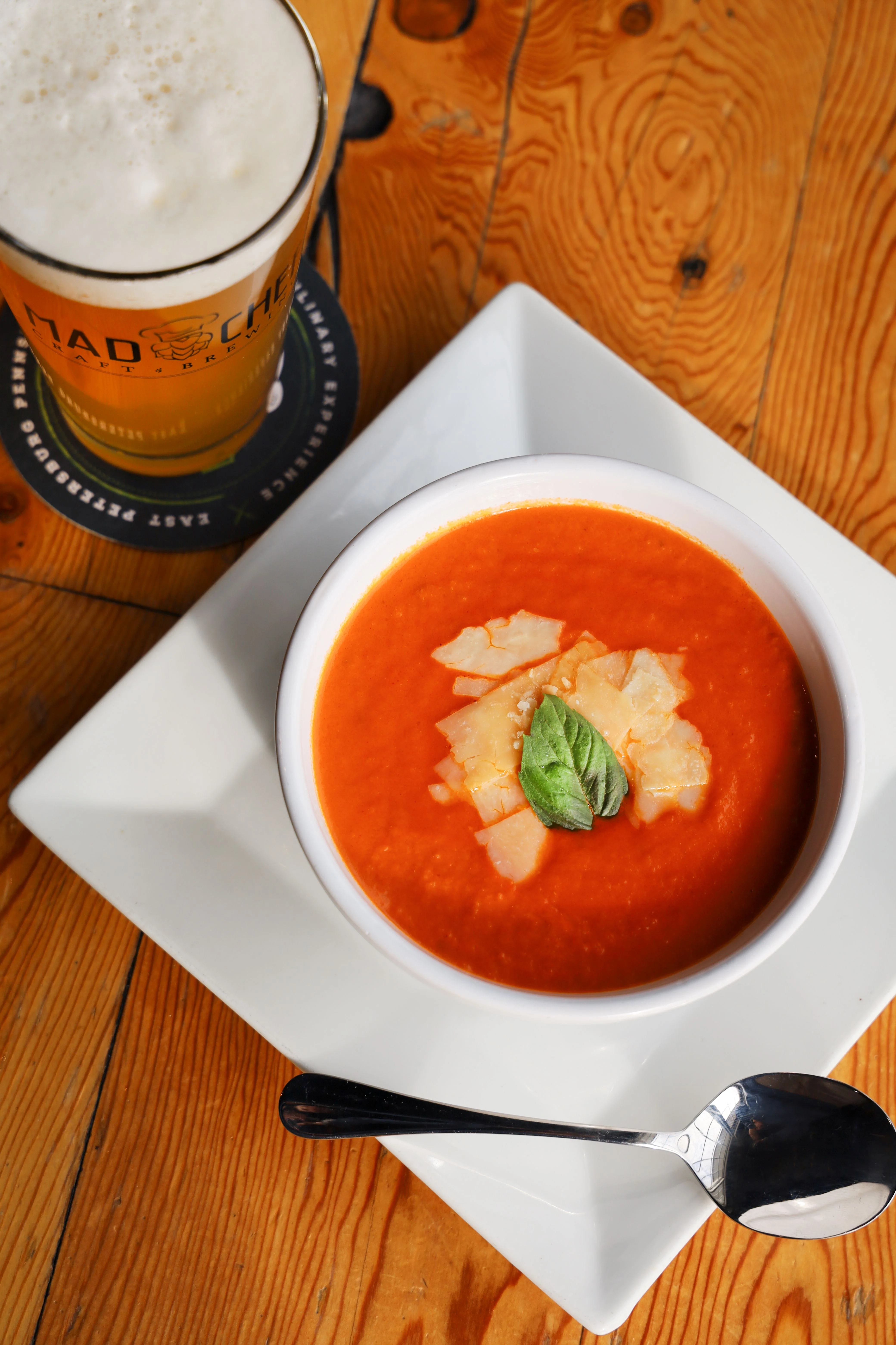 Creamy tomato basil soup served in a white bowl