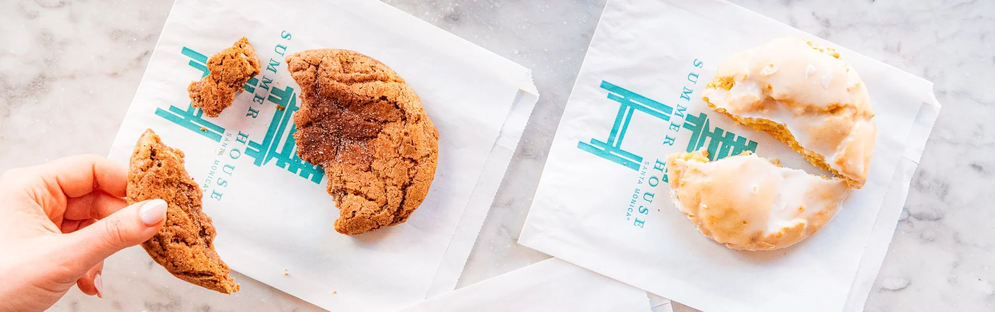 Freshly baked cookies and glazed donut on branded napkins