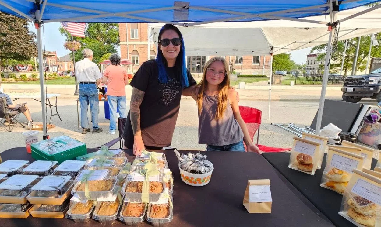 Local market stall with baked goods and friendly vendors