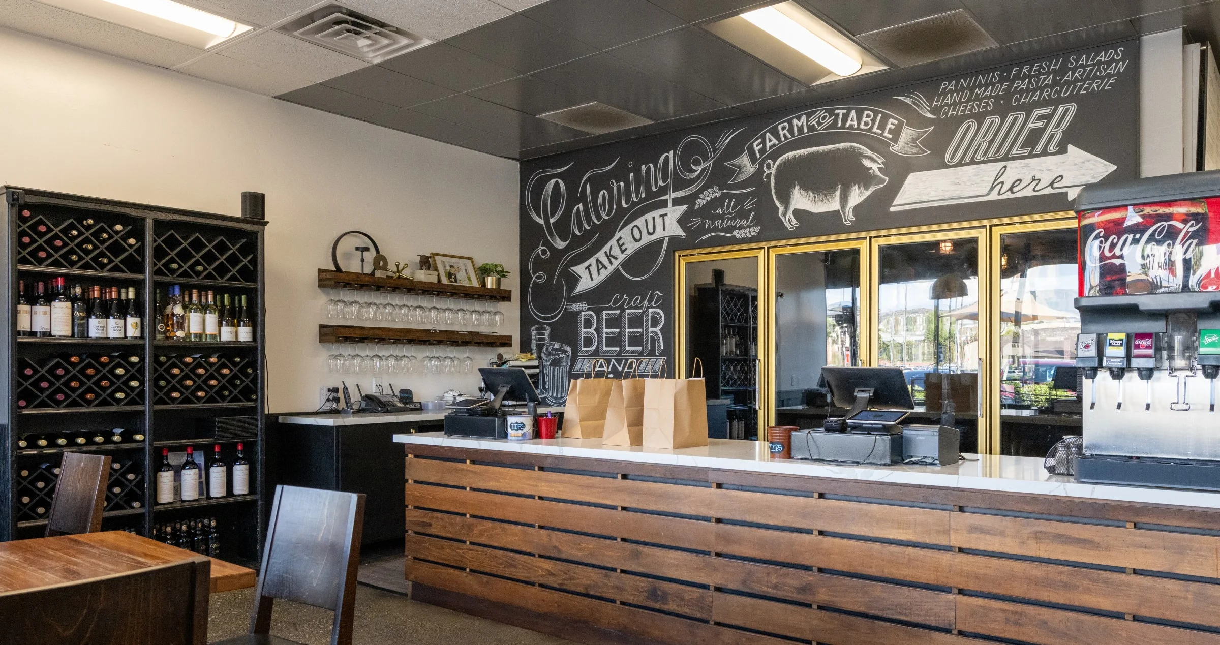 Cozy restaurant interior with wooden counter and wine display