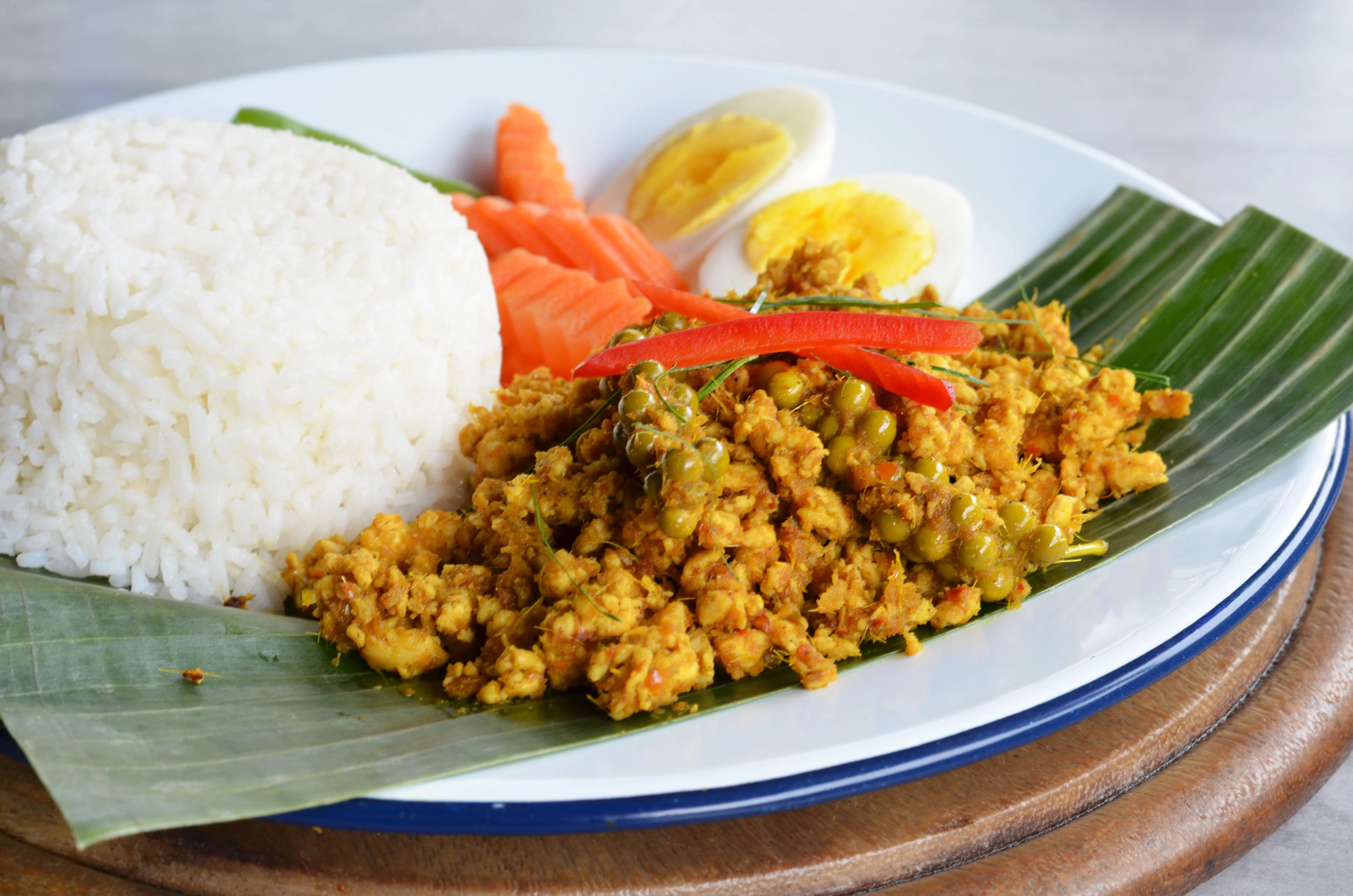 Indonesian nasi goreng with vegetables and boiled eggs
