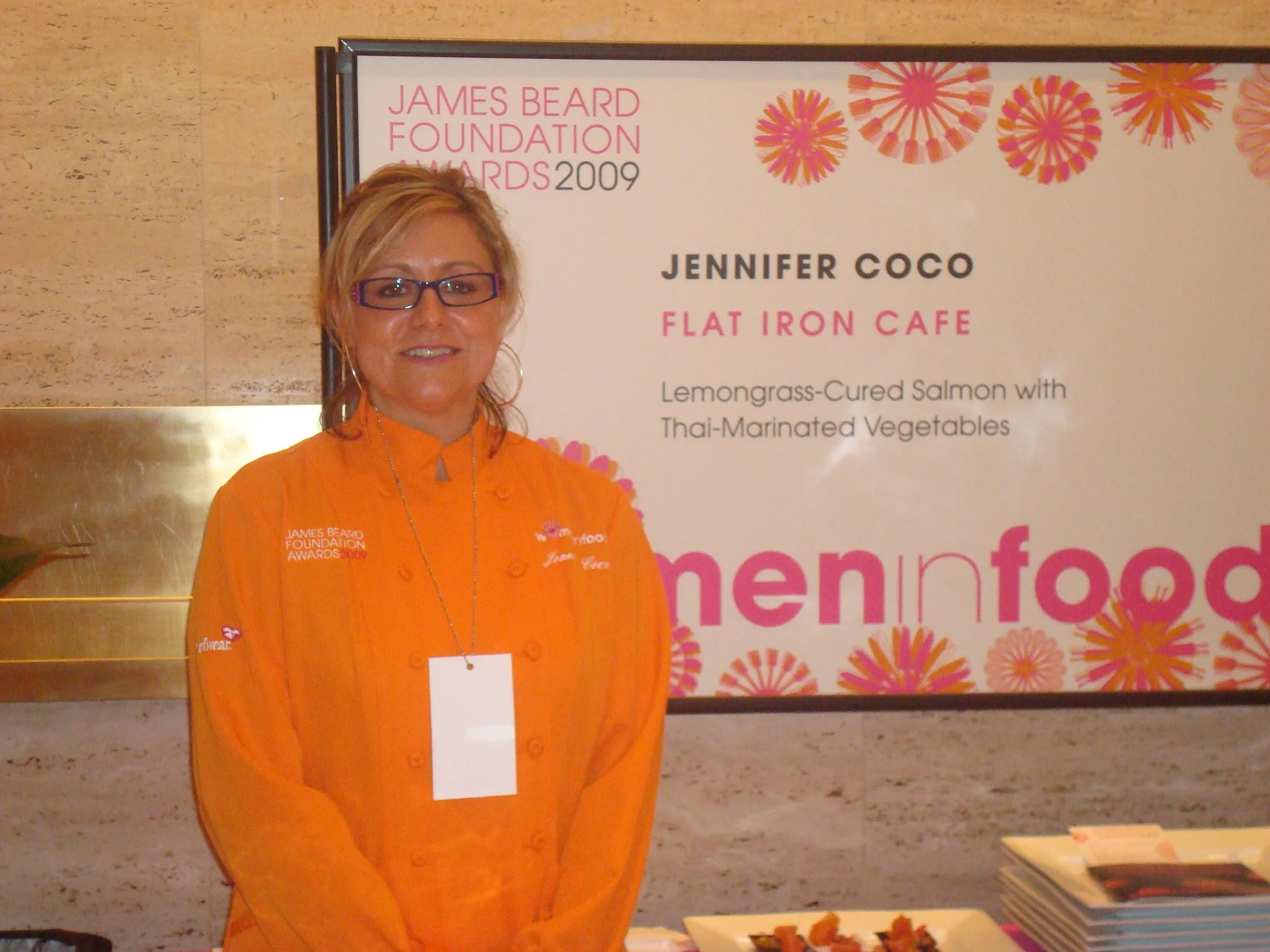 Chef presenting lemongrass-cured salmon at a culinary event
